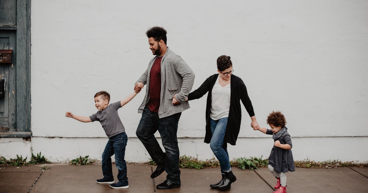 New Year’s Resolution Protect Your Family’s Future with Life Insurance - photo by Photo by Emma Bauso httpswww.pexels.comphotofamily-of-four-walking-at-the-street-2253879