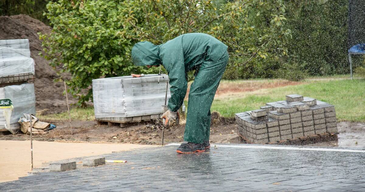 Top Insurance Considerations for Paving and Grading Contractors - Photo by Marianna Zuzanna: https://www.pexels.com/photo/worker-working-on-pavement-in-rain-16239805/