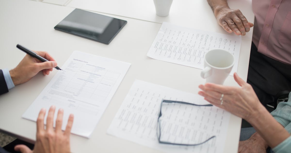 A person reviewing their insurance policies with their insurance agent in January - Photo by Kampus Production httpswww.pexels.comphotodocuments-on-the-table-8441777