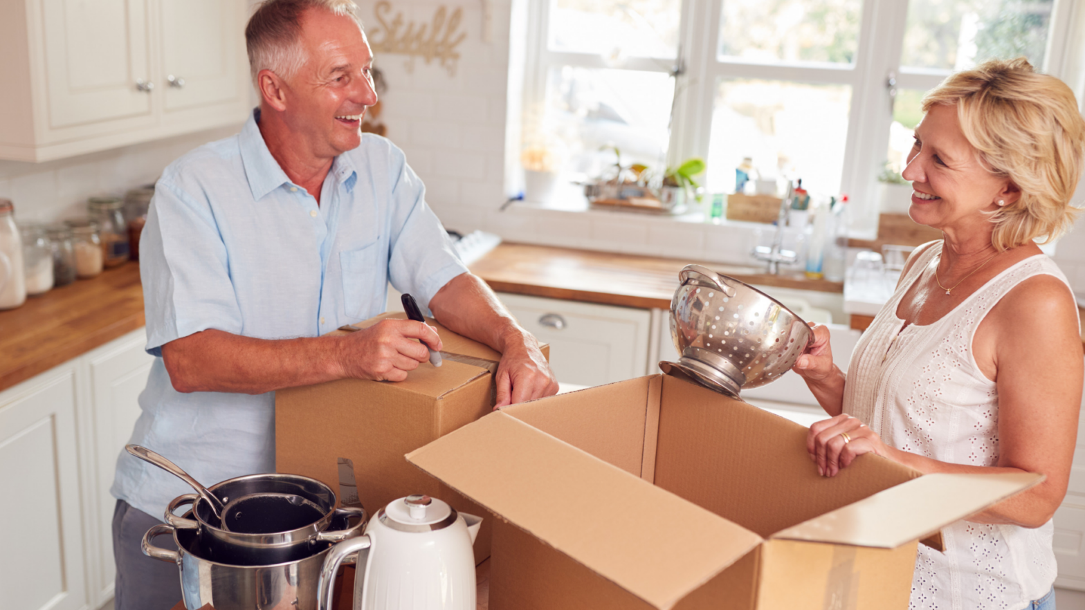 empty nesters packing after reviewing and adjusting their insurance policies